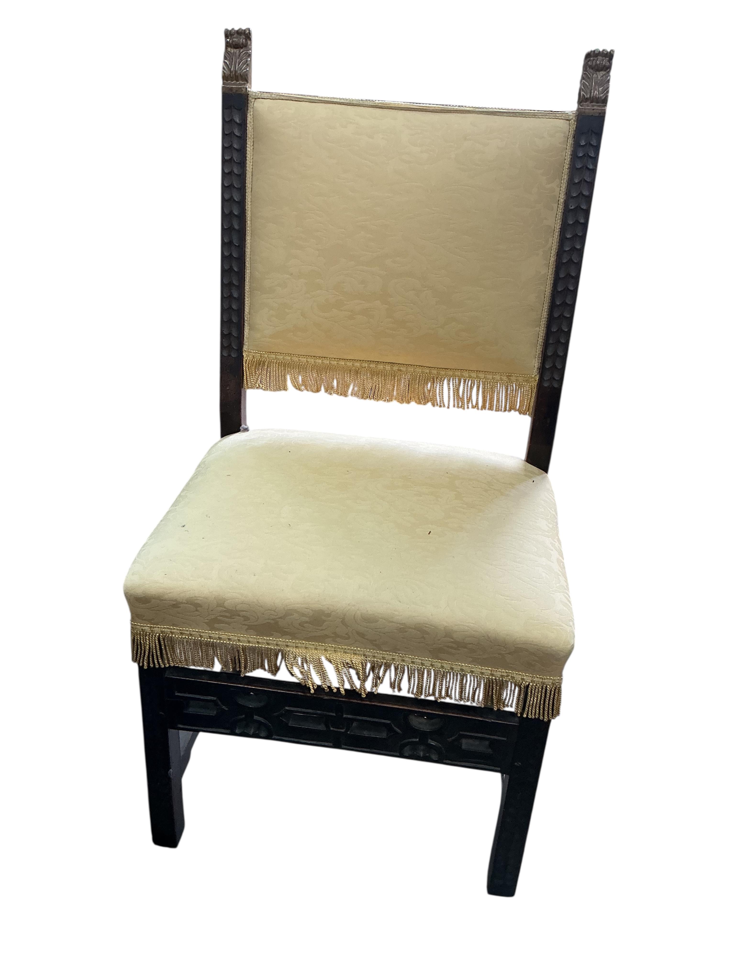 A pair of Italian side chairs carved with foliate bands, parcel gilt terminals and fretwork stretcher, upholstered in yellow damask, width 58cm, depth 48cm, height 118cm